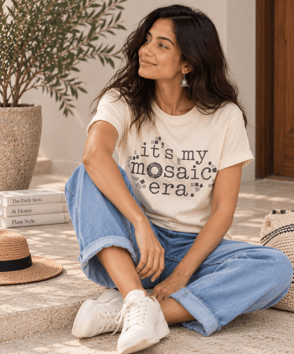 Mosaic Era Tee in Natural Cream, model seated on stone steps